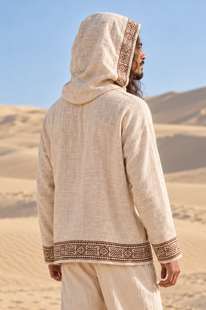 Back view of man in beige cotton hoodie with the hood up, block-printed band edging the hood opening
