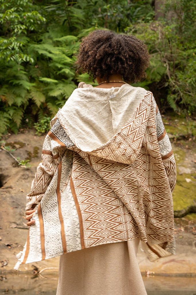 Introducing the JAPOMONO, a unique Jacket-Kimono-Poncho hybrid, it is an open hooded poncho handcrafted from natural cotton and naturally dyed in earthy tones.